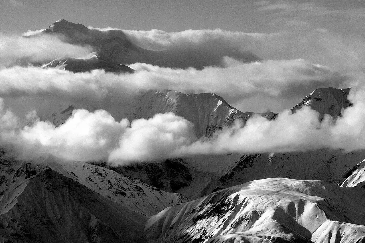 Mount McKinley rising above tundra and broken cloud in Denali National Park