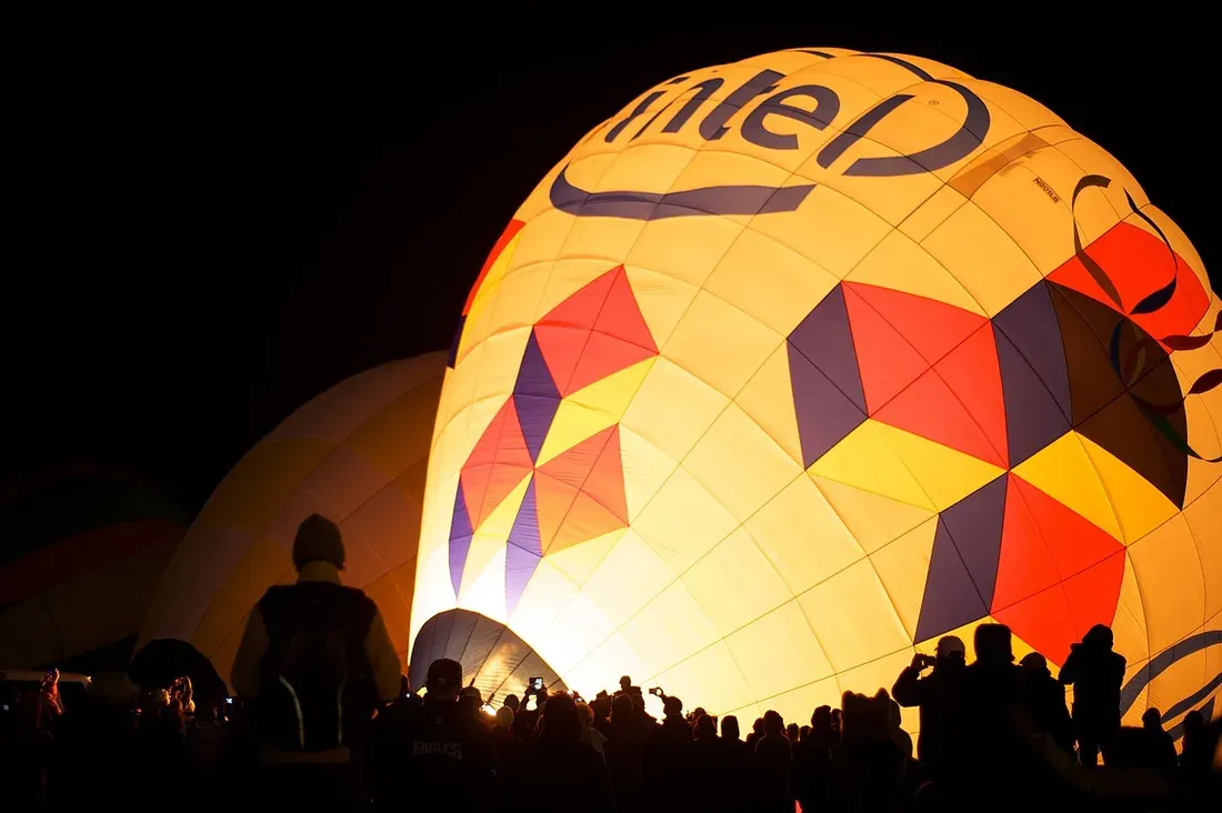 Predawn balloons glowing as Dawn Patrol lifts off at Balloon Fiesta