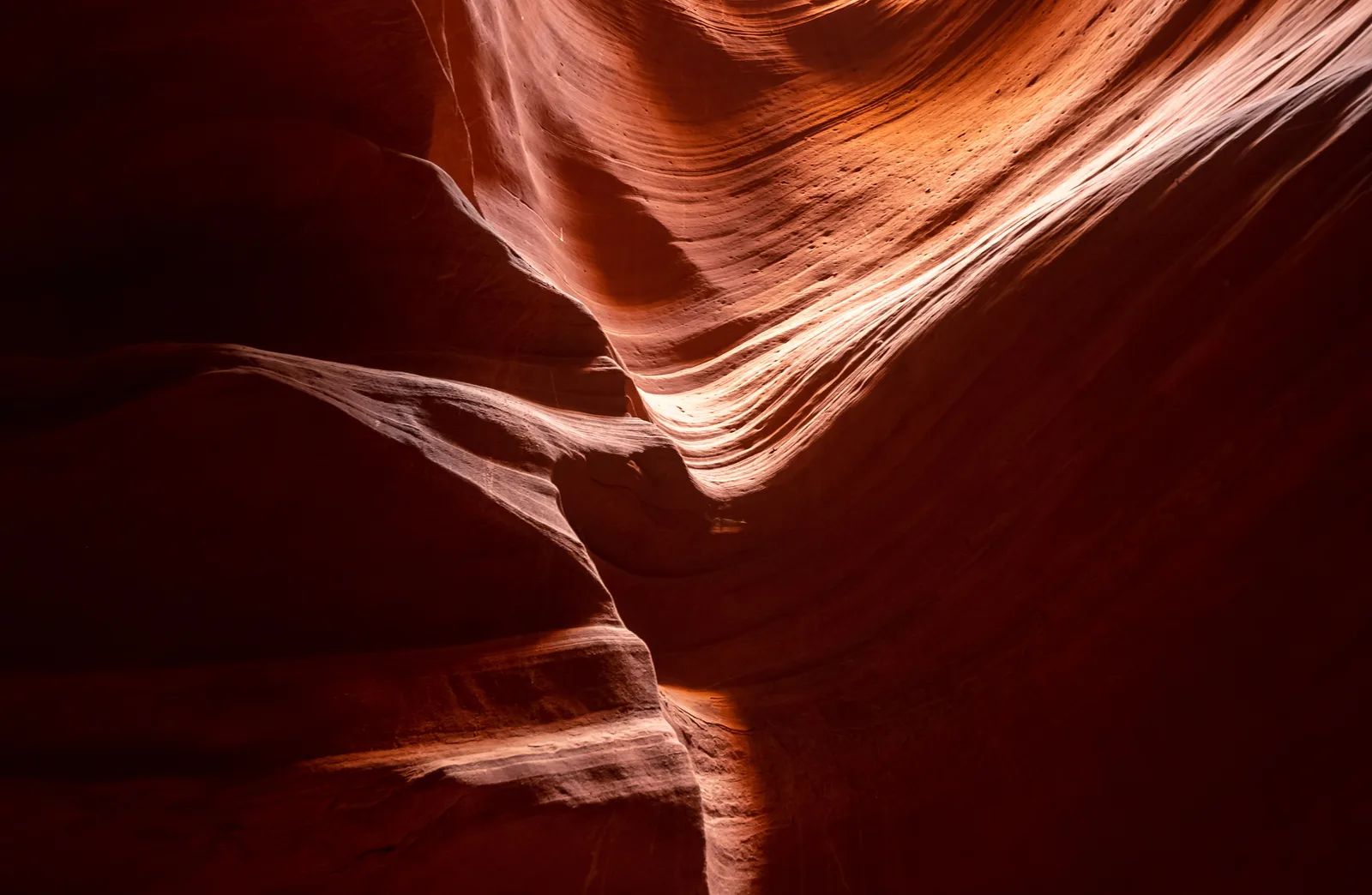 Curved orange sandstone walls lit from above inside Antelope Canyon near Page, Arizona