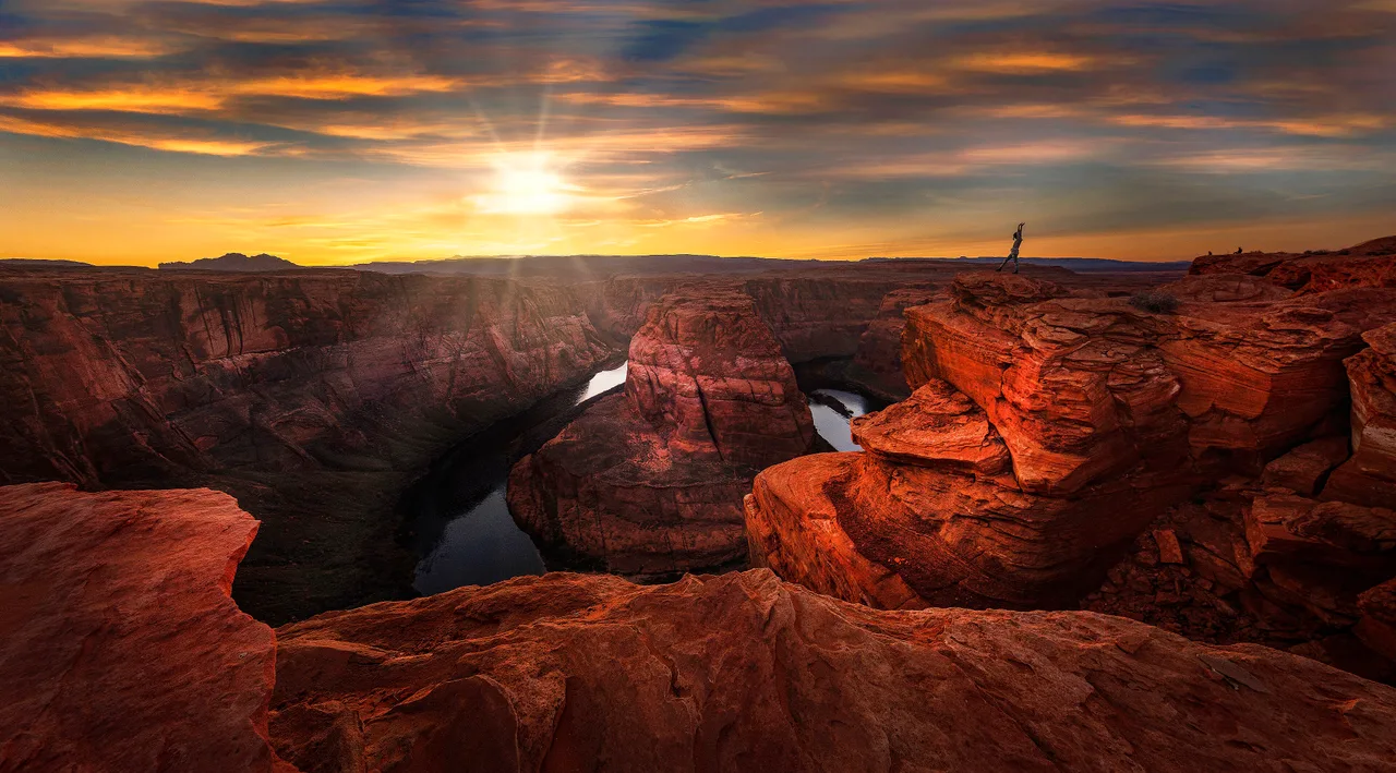 The Colorado River curving around a sandstone butte at Horseshoe Bend near Page at sunset