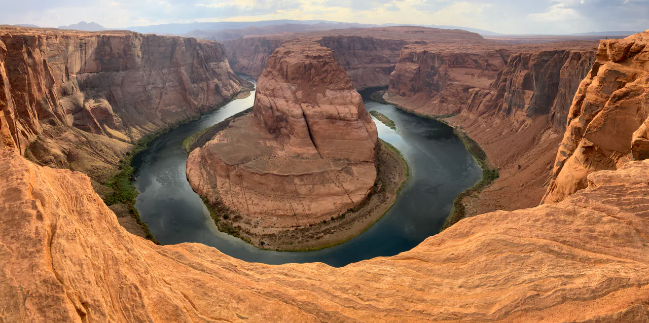 The Colorado River curving in a tight horseshoe meander below sandstone cliffs near Page, Arizona