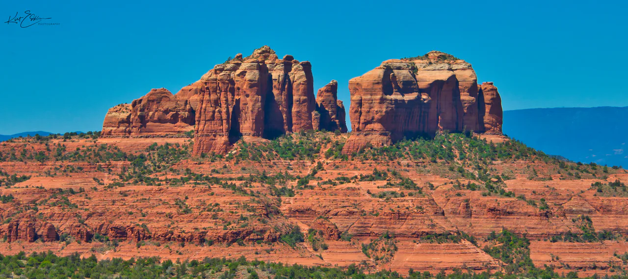 The red sandstone spires of Cathedral Rock rising above juniper scrub near Sedona, Arizona