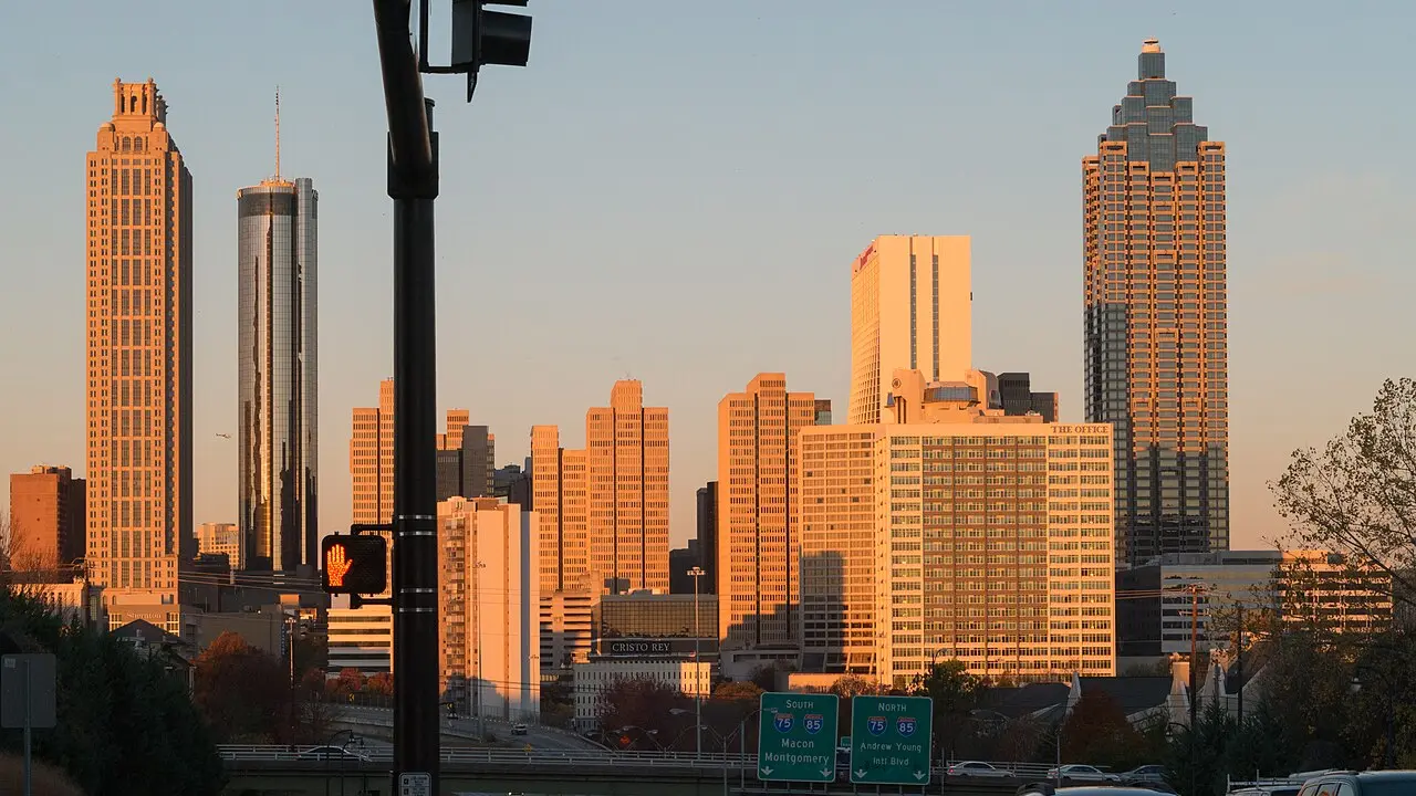 Pink sunrise light on the downtown Atlanta skyline along Freedom Parkway