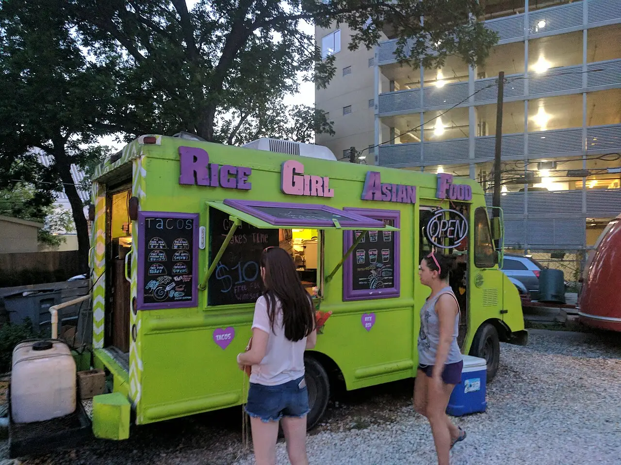 A cluster of food trucks on a lot in south Austin