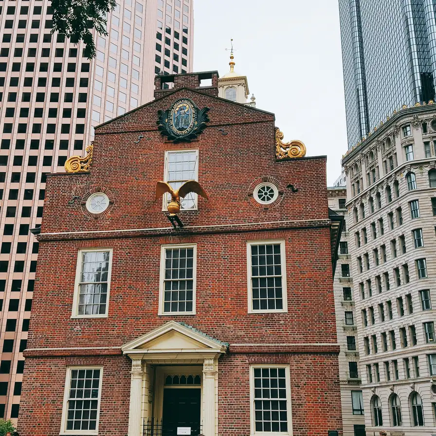 The brick Old State House with its gold lion and unicorn surrounded by modern towers in downtown Boston