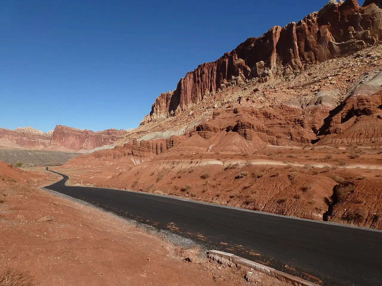 The paved Scenic Drive winding beneath red cliffs in Capitol Reef National Park