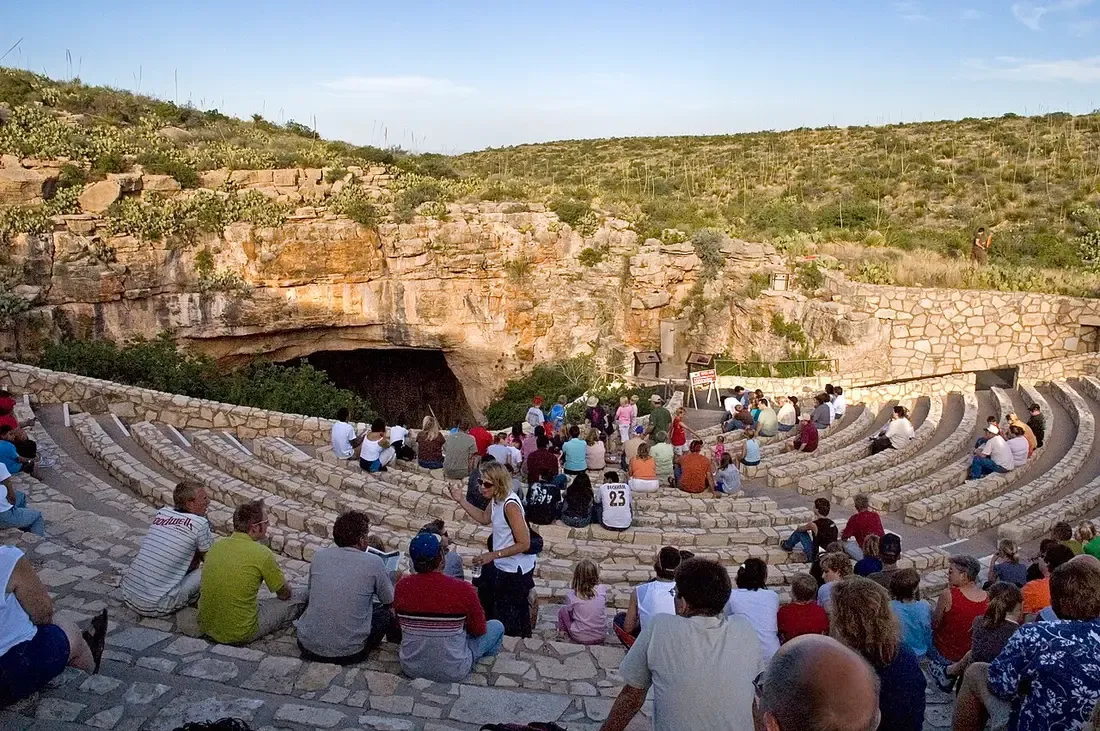 Visitors seated in the Bat Flight Amphitheater before dusk at Carlsbad Caverns