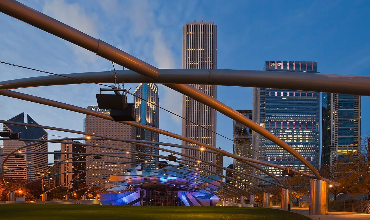 The stainless steel ribbons of the Jay Pritzker Pavilion above the lawn in Millennium Park