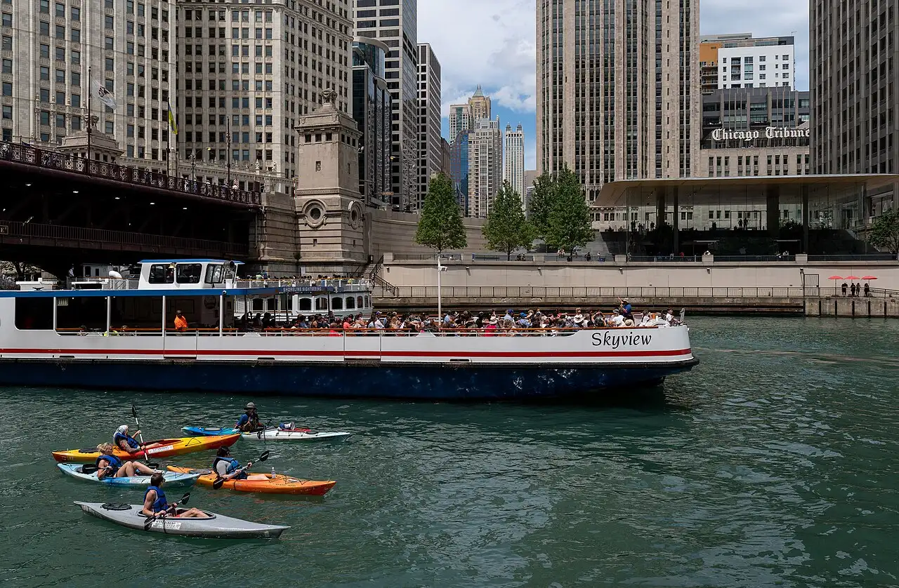 Tour boats and kayaks on the Chicago River beside the Riverwalk
