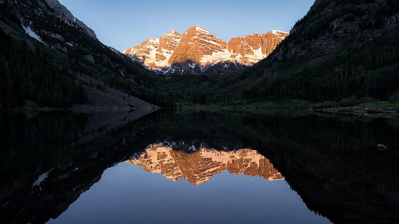 The Maroon Bells at sunrise reflected in Maroon Lake near Aspen, Colorado
