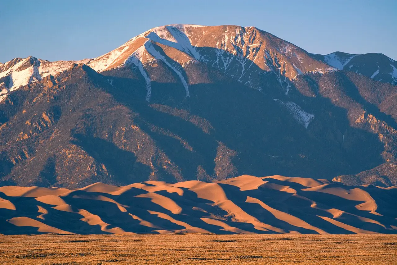 Sand dunes below the snow-capped Sangre de Cristo mountains at Great Sand Dunes National Park