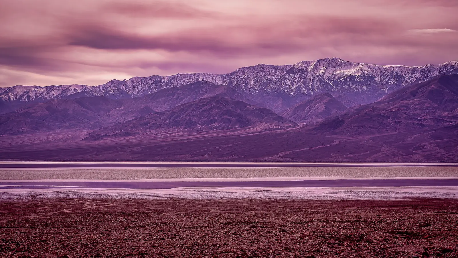 The white salt flats of Badwater Basin stretching toward the mountains in Death Valley National Park