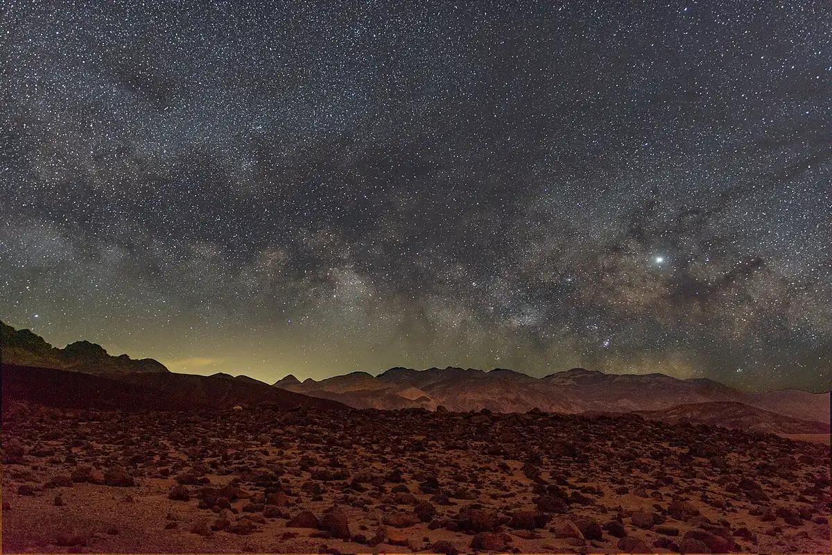 Star-filled night sky over the desert landscape of Death Valley National Park