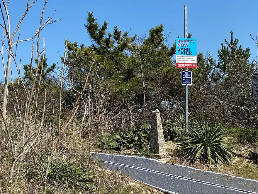 Entrance sign and road leading toward Lewes Beach