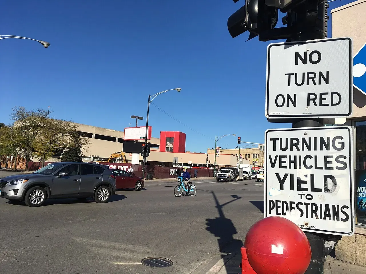 No turn on red traffic sign above an urban intersection with a shared bike
