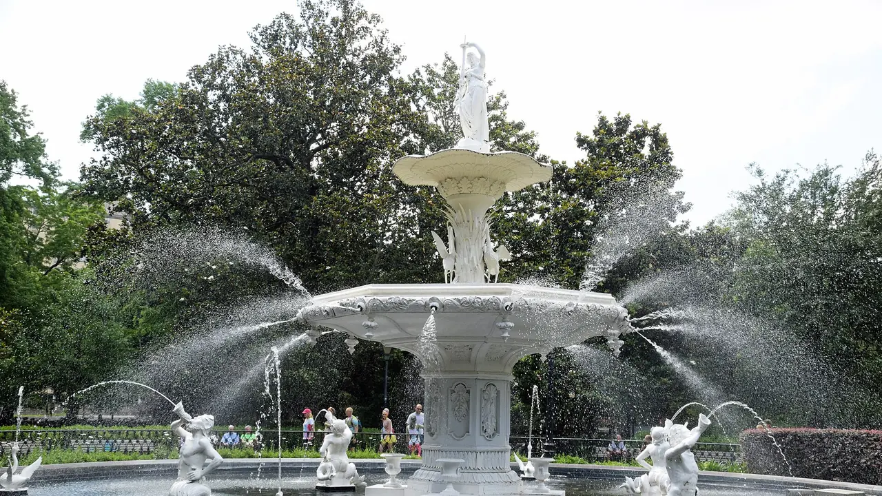 The white fountain in Forsyth Park framed by live oaks and Spanish moss in Savannah, Georgia