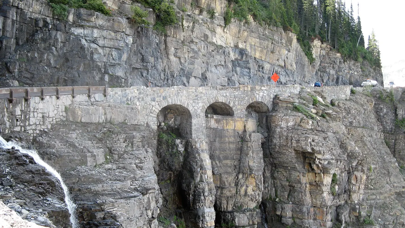 Going-to-the-Sun Road clinging to a cliff face above a glacial valley in Glacier National Park
