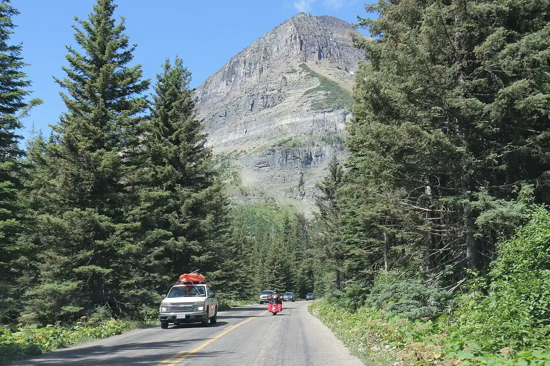 Cars lined up along Going-to-the-Sun Road in Glacier National Park in summer