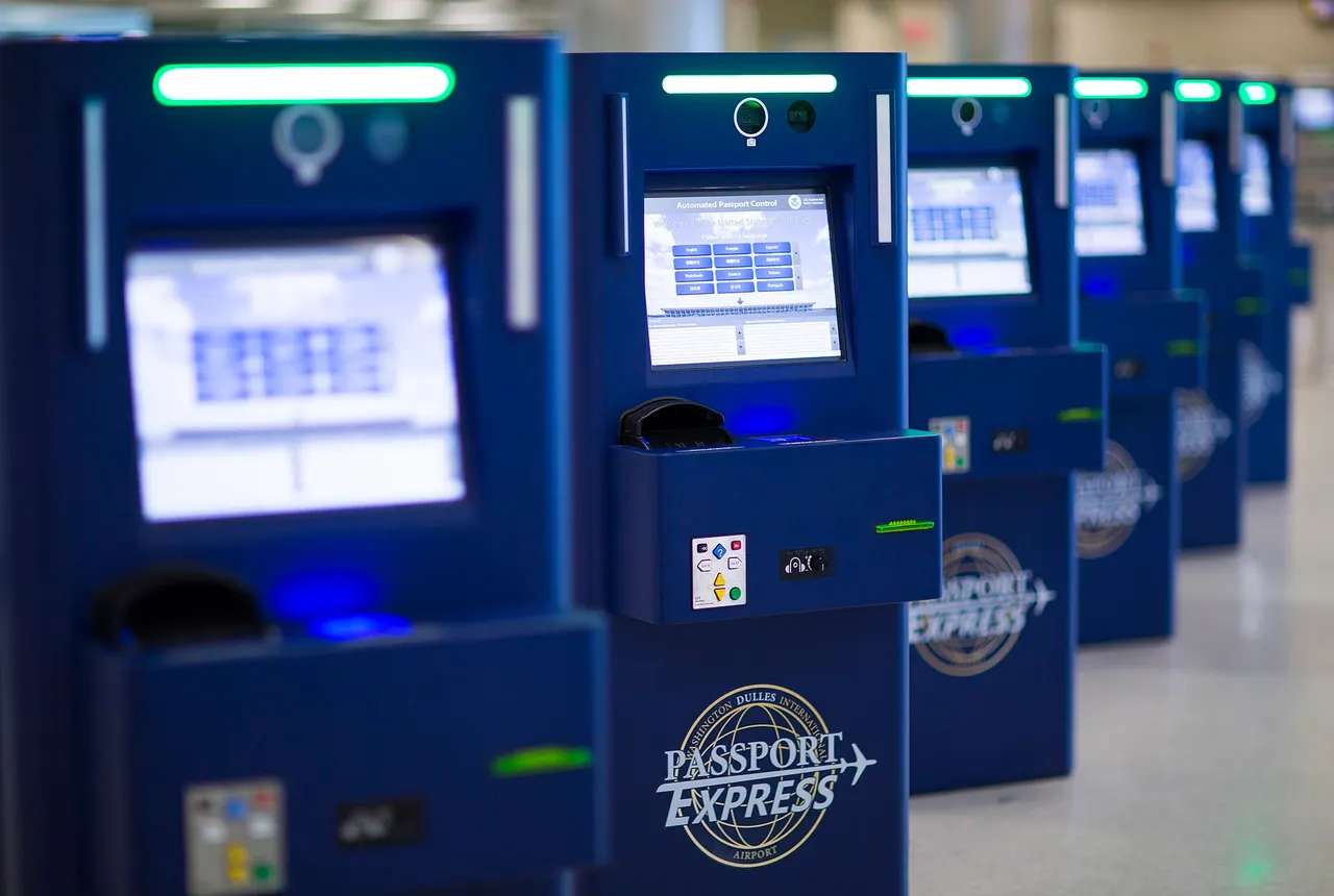 Automated Passport Control kiosks at Washington Dulles showing a language-selection welcome screen