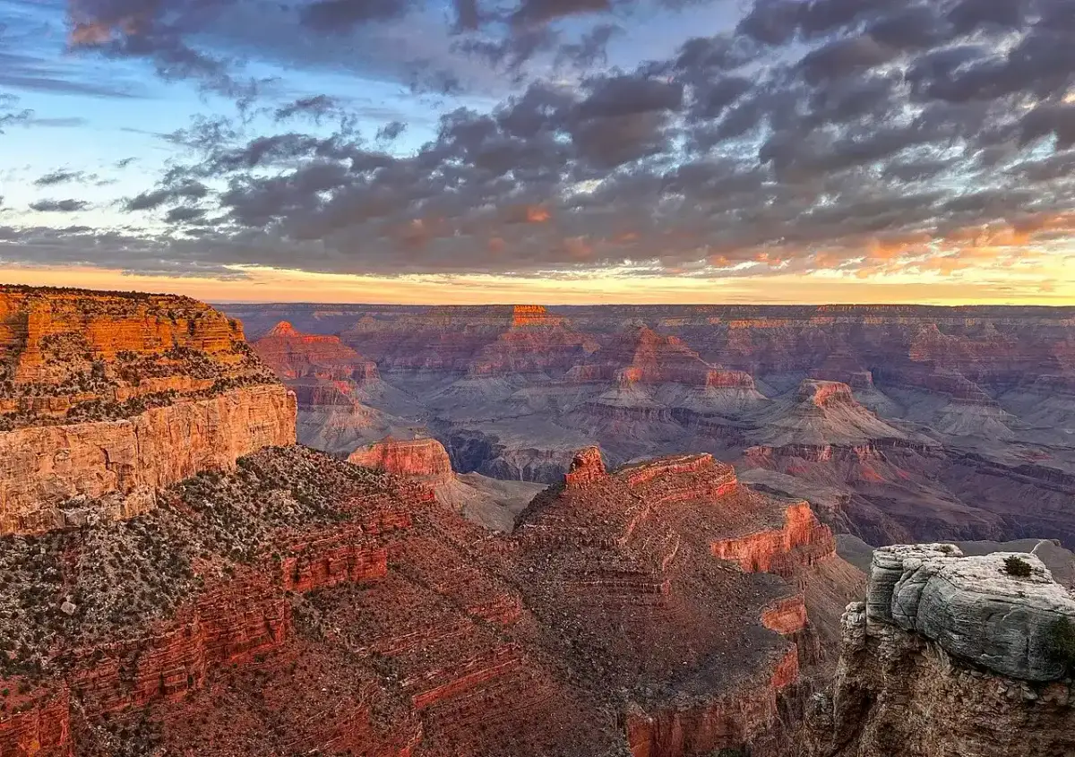 Sunrise light over the layered canyon walls seen from Grand Canyon Village on the South Rim