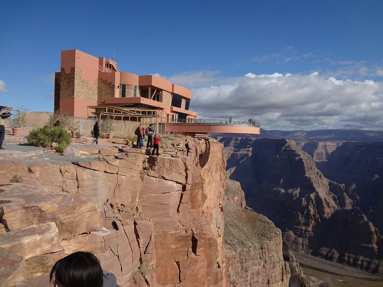 The Skywalk terminal building and glass bridge extending out over the canyon rim at Grand Canyon West