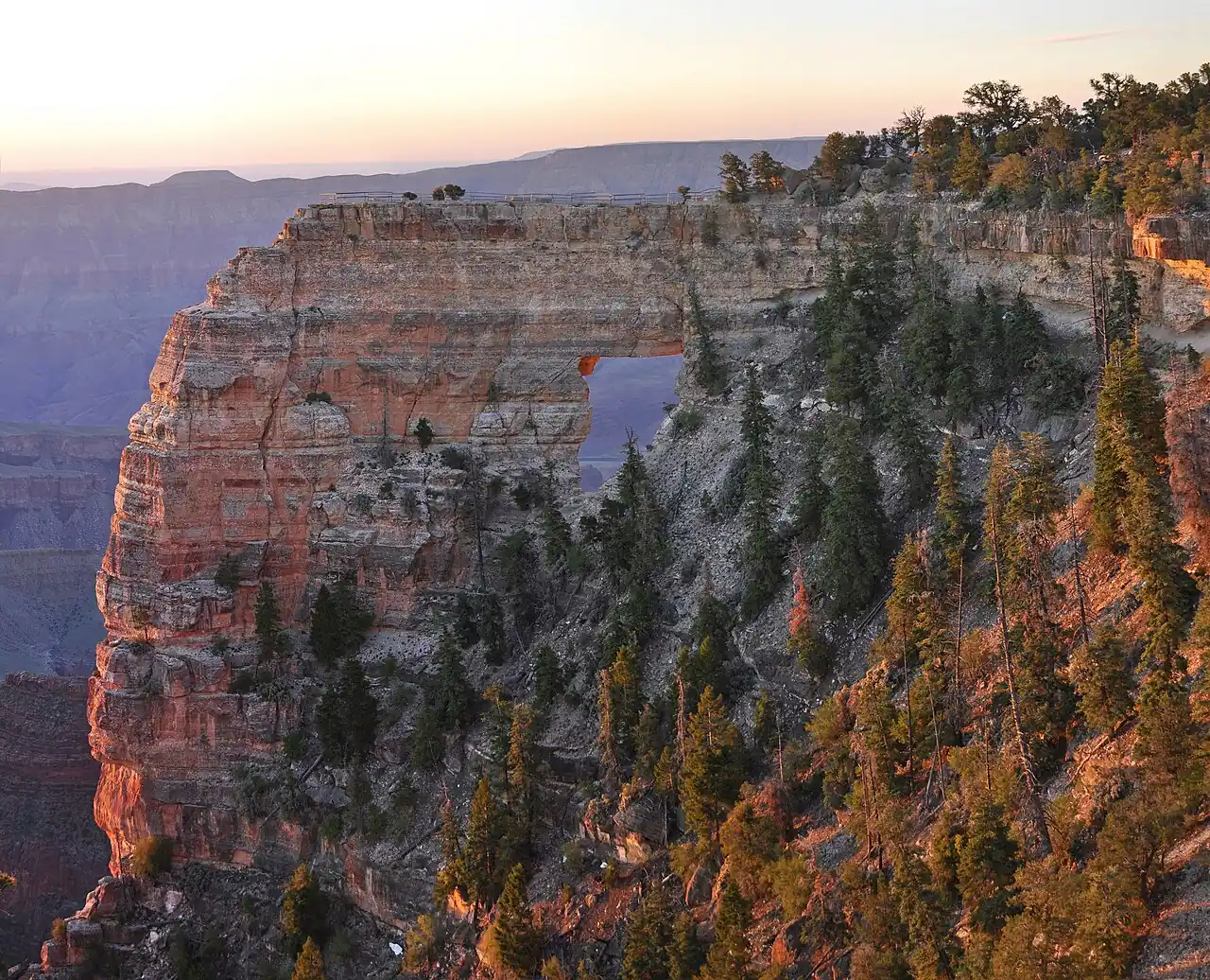 Sunrise light on Angels Window, a natural rock arch on the North Rim of the Grand Canyon