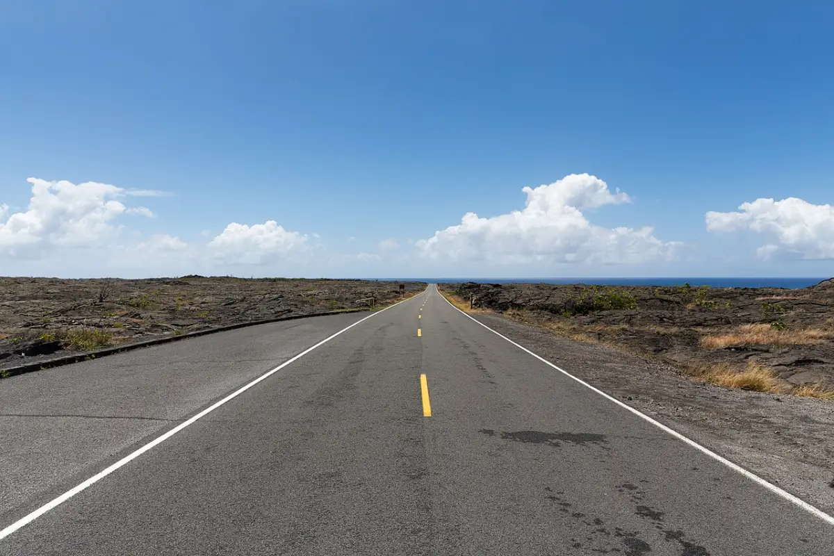 Chain of Craters Road winding across dark lava fields toward the coast