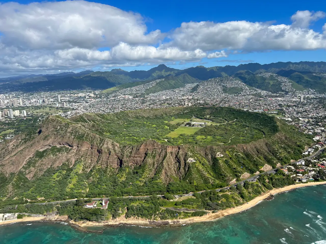 Aerial view of the Diamond Head crater rim above Honolulu with the ocean beyond