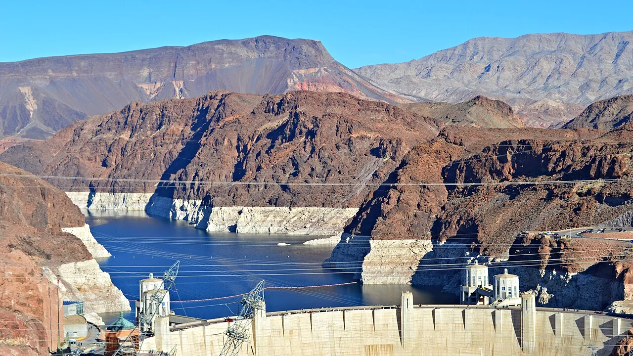 Looking across the curved face of Hoover Dam toward the Colorado River and the Arizona intake towers