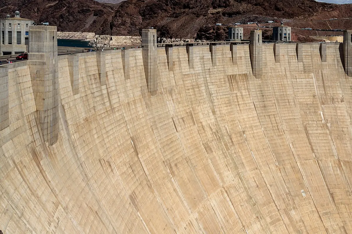 The concrete arc of Hoover Dam spanning Black Canyon with the Colorado River below