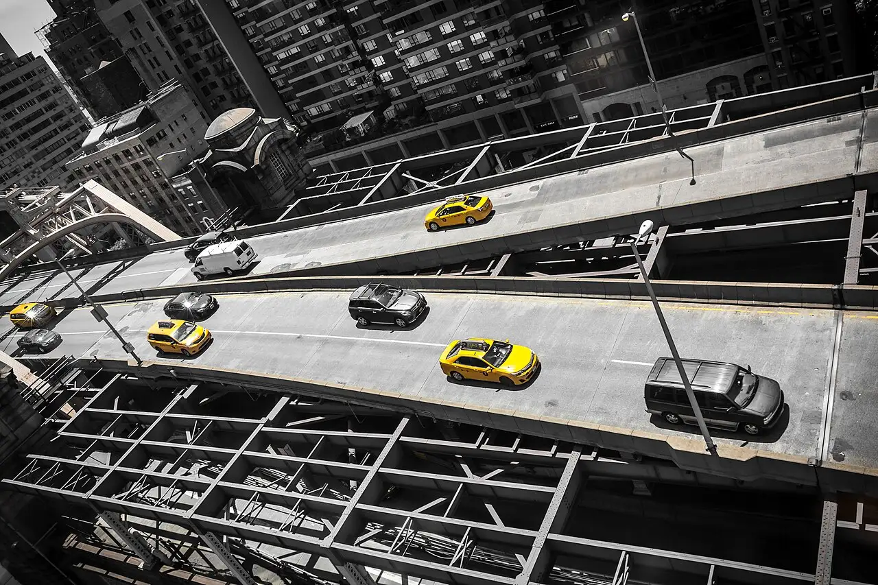 A row of yellow taxis waiting on a New York City street