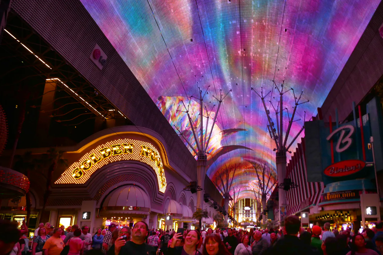 Crowds under the illuminated LED canopy of the Fremont Street Experience in downtown Las Vegas