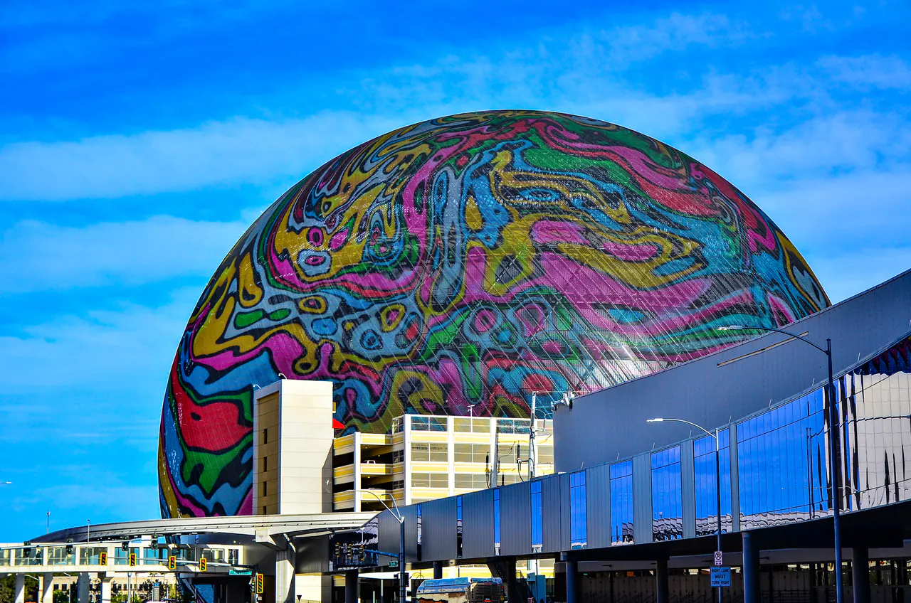 The spherical LED exterior of Sphere lit up beside the Las Vegas Strip
