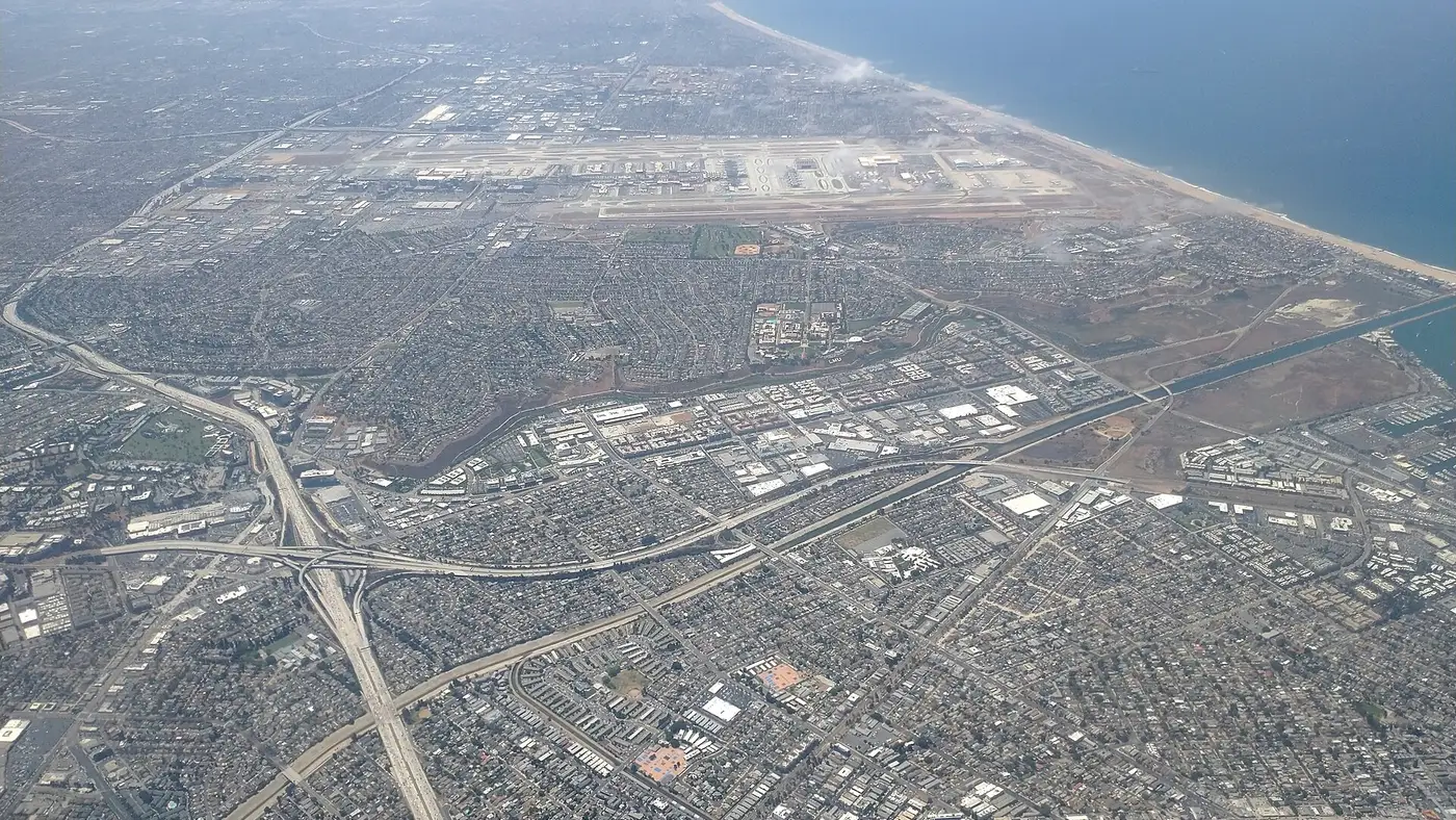 Aerial view of Los Angeles International Airport terminals and surrounding coastal neighborhoods