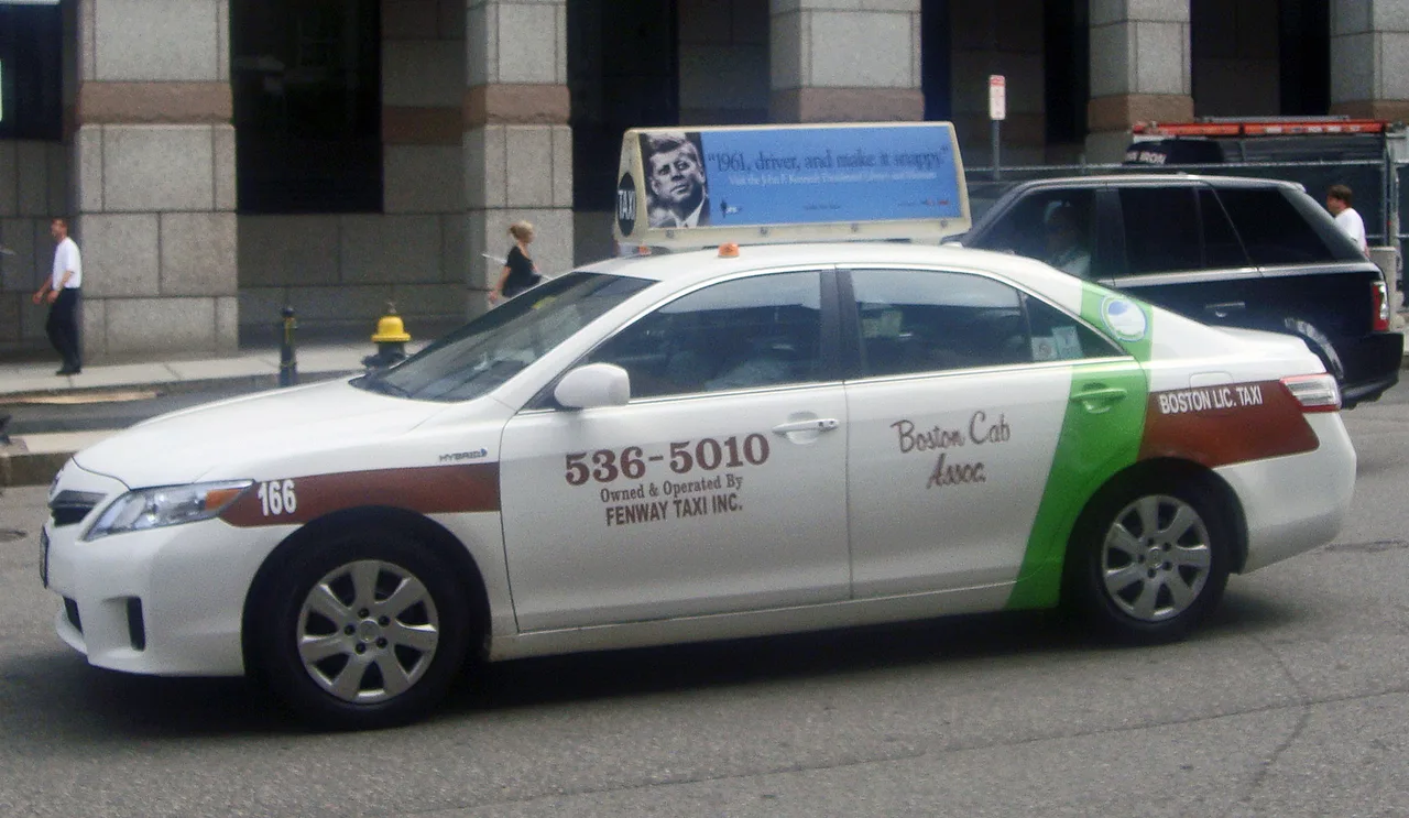 A licensed Boston taxi cab parked on a city street
