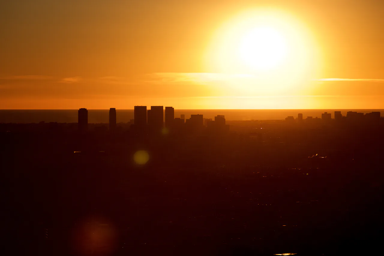 Griffith Observatory on its hillside above Los Angeles with the city skyline behind at sunset