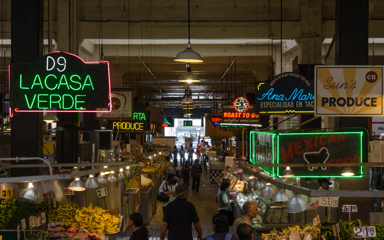 Neon signs and food stalls inside Grand Central Market in downtown Los Angeles