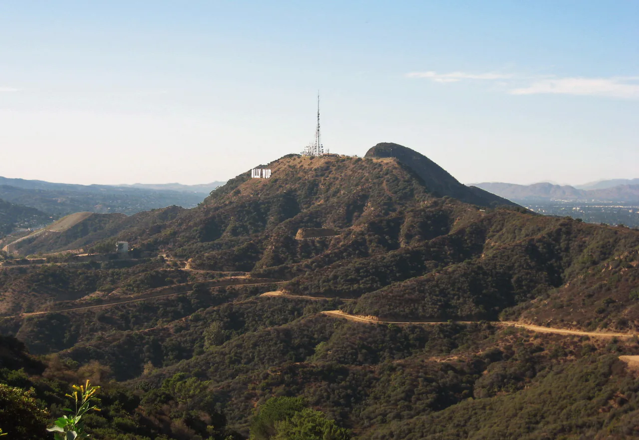 The Hollywood Sign in white letters on the brown slope of Mount Lee