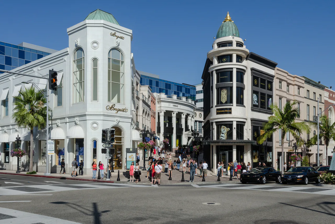 Luxury storefronts and palm trees along Rodeo Drive in Beverly Hills