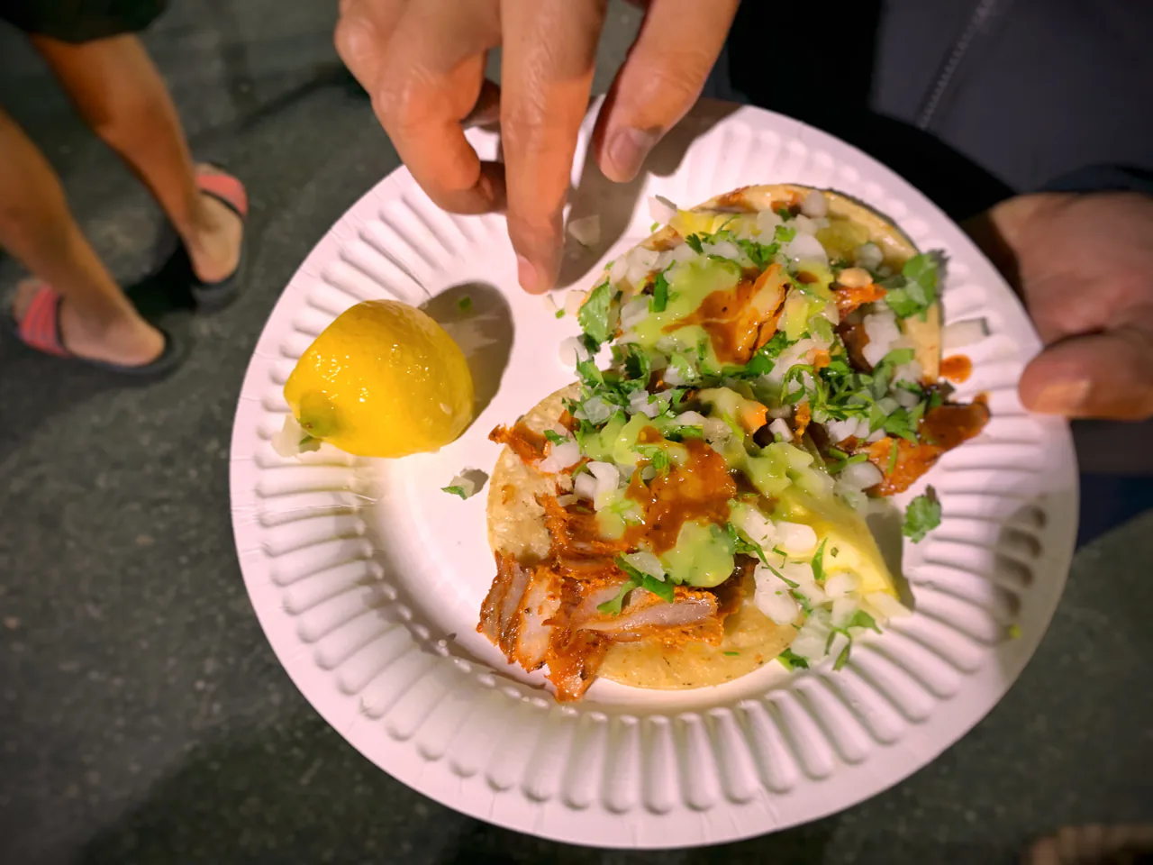 Tacos al pastor with pineapple and cilantro from a Los Angeles taco truck