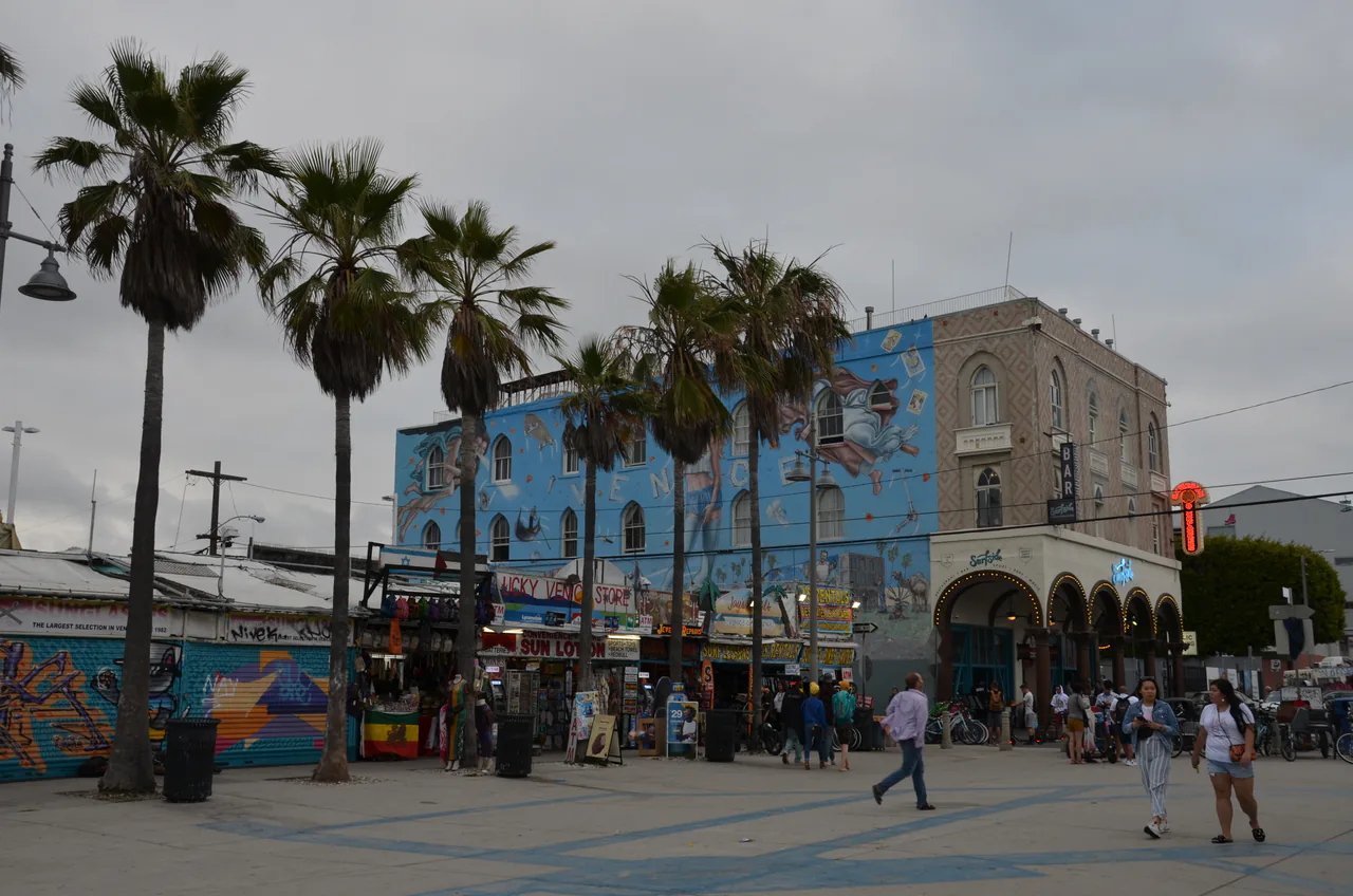 Crowds, palm trees and stalls along the Venice Beach boardwalk