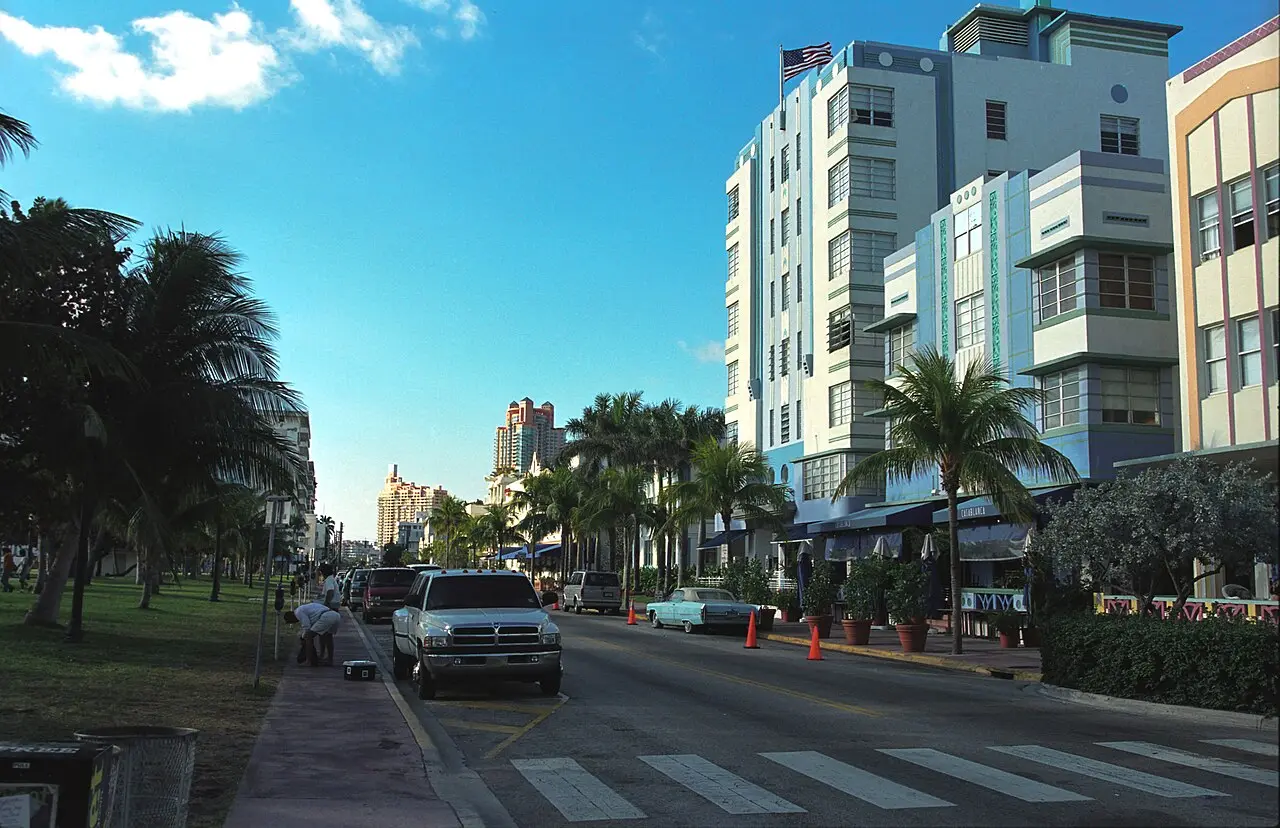 Palm-lined Ocean Drive with Art Deco hotels and cars in South Beach