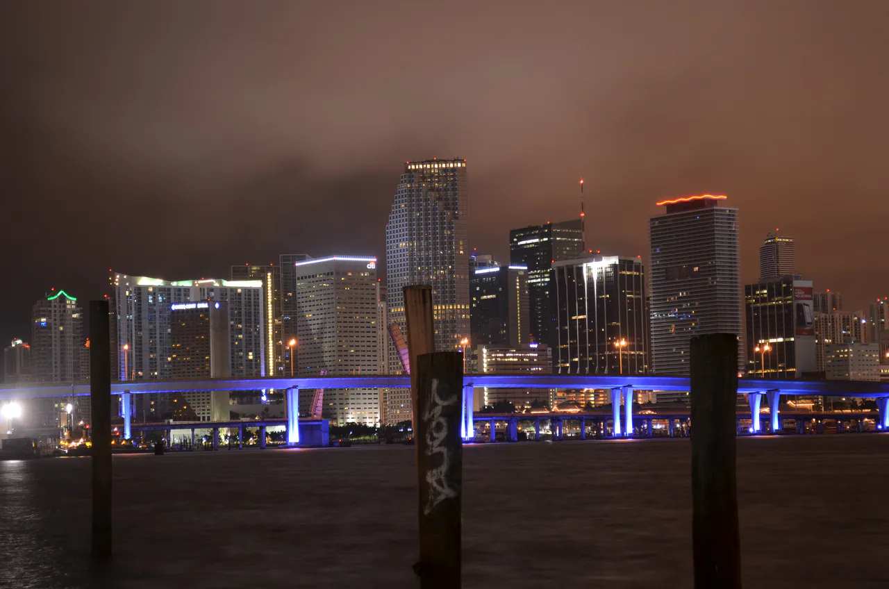 The downtown Miami skyline lit up at night seen across Biscayne Bay