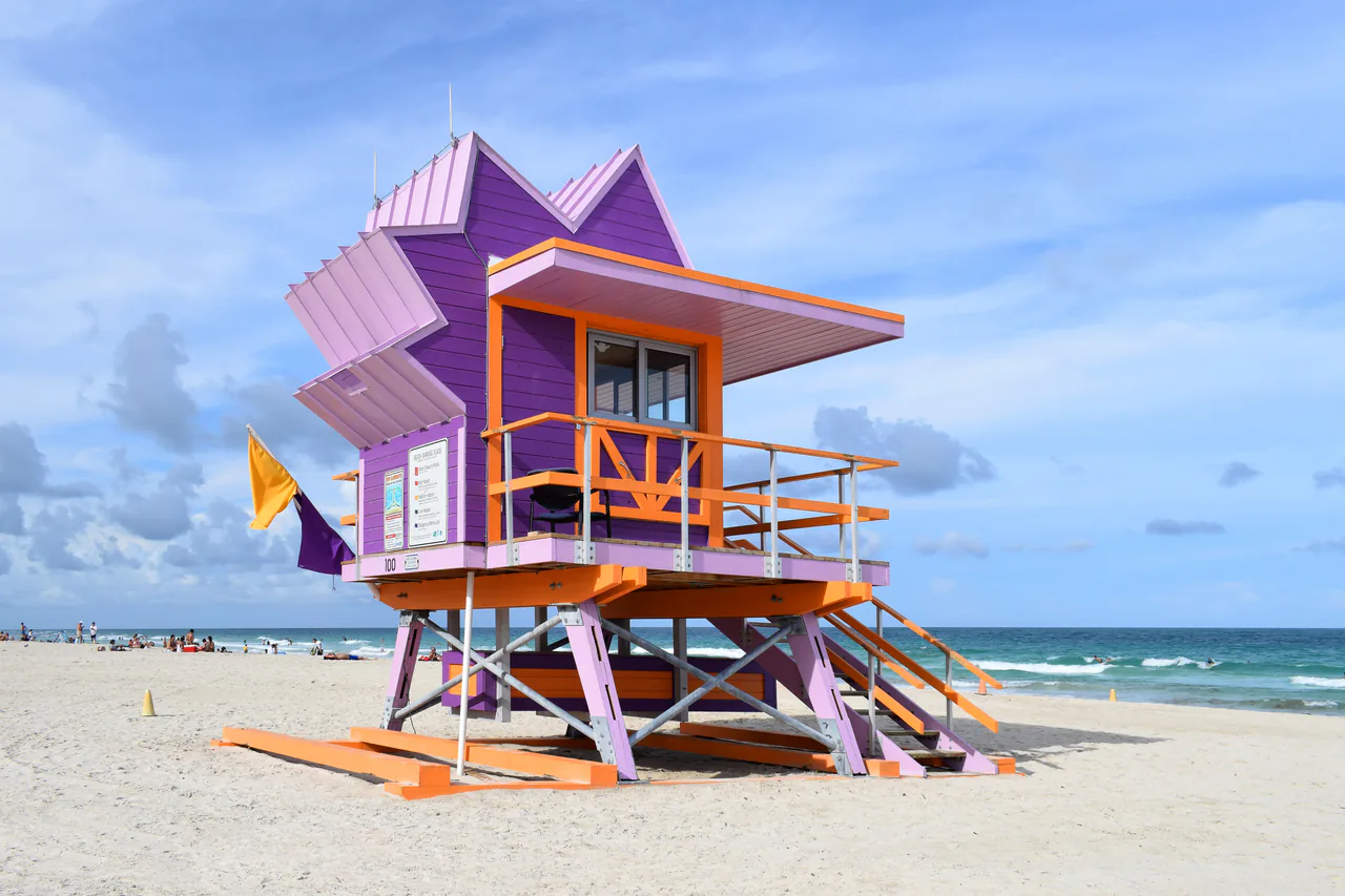 A brightly painted Art Deco lifeguard hut on the sand at South Beach
