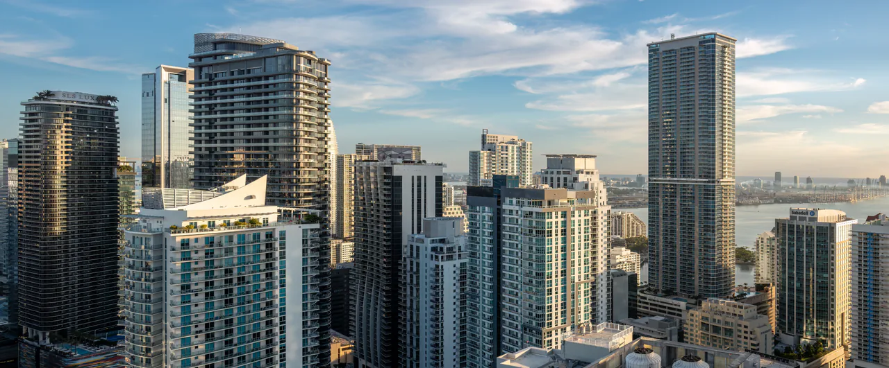 Glass towers of the Brickell financial district under a blue sky