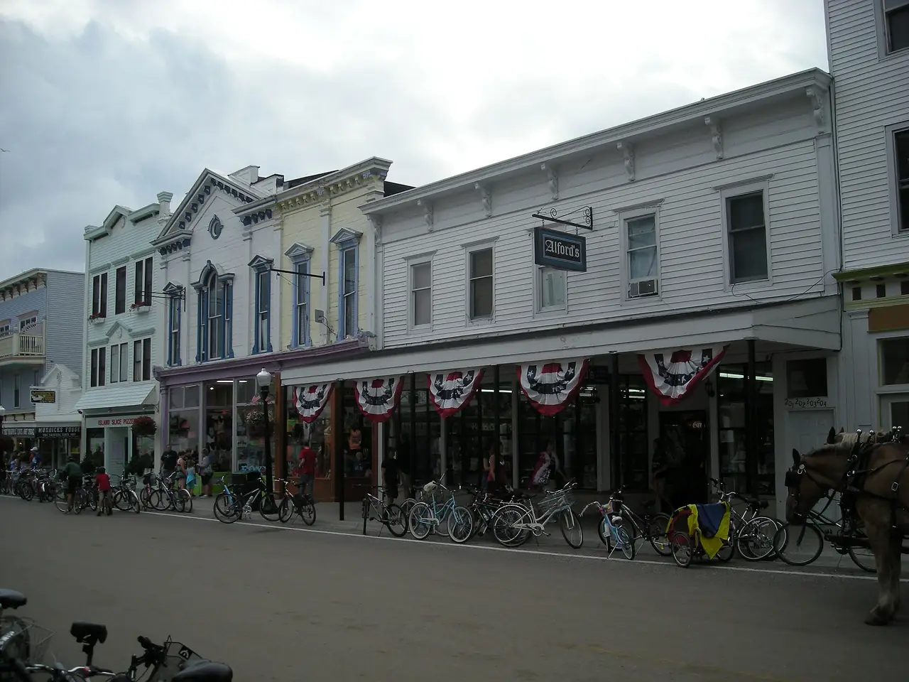 Main Street on Mackinac Island with bicycles and storefronts, no cars