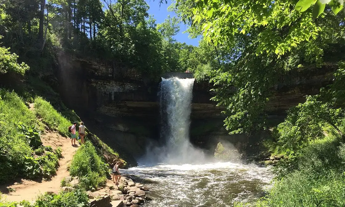 Minnehaha Falls cascading over limestone in a wooded Minneapolis park