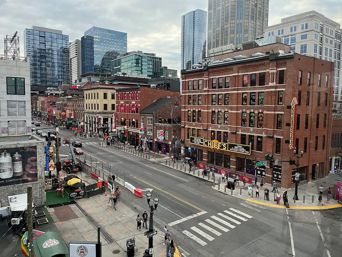 Broadway in Nashville by day with honky-tonk signs and pedestrians
