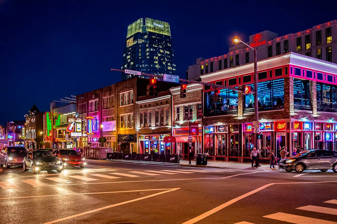 Neon signs and crowds along Lower Broadway in Nashville at night