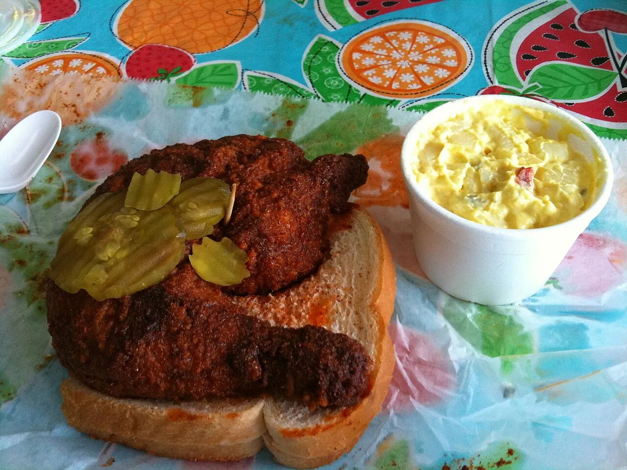 Nashville hot chicken served on white bread with pickles